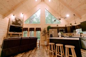 eine Küche und ein Wohnzimmer einer Hütte in der Unterkunft Secluded Wooden Cabin with Fire Pit, Barbecue and Hot-tub in Campbellsville, Kentucky in Campbellsville