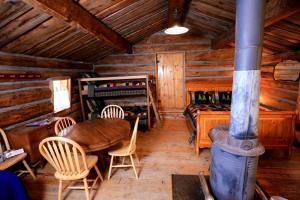 a dining room with a table and chairs in a cabin at Unique Camping Cabin Tucked in Wilderness near Steamboat Springs, Colorado in Columbine