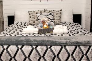 a bedroom with a bed with a basket of towels at Contrast Cove Dome in Smoky Mountains in Hartford, Tennessee in Hartford +16 photos