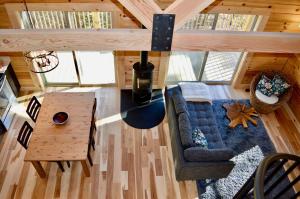 an overhead view of a living room with a couch and a table at Luxury Log Cabin with Mountain and Forest Views near Asheville, North Carolina in Goodluck