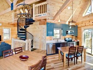 a kitchen and dining room with a spiral staircase in a log cabin at Luxury Log Cabin with Mountain and Forest Views near Asheville, North Carolina in Goodluck
