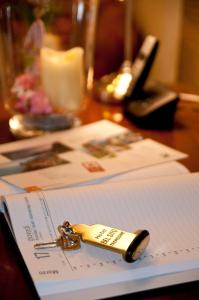 a key sitting on top of a paper on a table at Hotel Garni Bel Sito in Tremosine Sul Garda