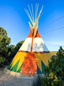 a colorful kite is sitting on the ground at Secluded Pet Friendly Tipi with Barbecue in Monticello, Utah in Verdure
