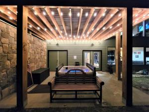 a patio with a ping pong table in a building at Fantastic Cabin with Pool Table and Games in Gartlinburg, Tennessee in Chalet Village