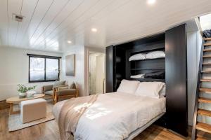 a bedroom with a large bed and a staircase at Lovely Secluded A-frame with Hot-tub in Sundance, Utah in Sundance