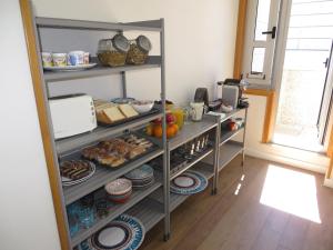 a pantry with shelves filled with food and other items at Toctoc Rooms in A Coruña