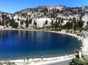 people standing on the beach near a large lake at Cozy Vacation Cottage Rental near Lassen Volcanic National Park, Northern California in Shingletown