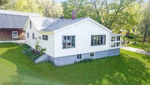 an aerial view of a white house at Embrace Nature in this Breathtaking Cottage in Portage Lake, Maine in Portage Lake Municipal Seaplane Base