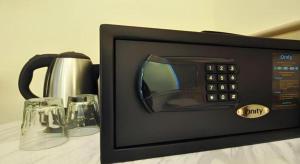 a microwave on a table with two glasses at King's Hotel in Hong Kong