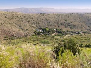 a view from the top of a hill with a village in the distance at Peaceful Vacation Suite Rental Overlooking Mescal Canyon in Clarkdale, Arizona in Jerome