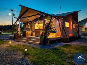 a house with a roof with lights on it at Glorious Tented Cabin with Fire Pit and Gorgeous Sky Views in Sevierville, Tennessee in Wear Valley
