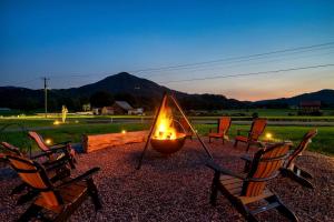 a group of chairs with a fire in a fire pit at Glorious Tented Cabin with Fire Pit and Gorgeous Sky Views in Sevierville, Tennessee in Wear Valley