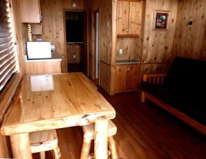 a room with a wooden table in a cabin at Gorgeous Cabin with Stunning Views in West Yellowstone, Montana in Lakeview