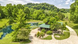 an aerial view of a house with a river and trees at Exquisite Cabin with Amazing Interior and Exterior in Sarahsville, Ohio in Senecaville