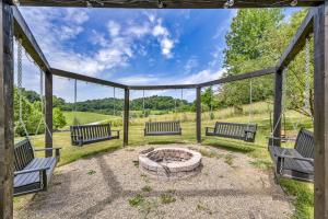 a group of benches sitting around a fire pit at Exquisite Cabin with Amazing Interior and Exterior in Sarahsville, Ohio in Senecaville
