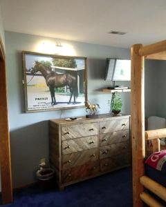 a bedroom with a dresser with a picture of a horse on the wall at Cozy Bed and Breakfast Suite for Romantic Getaway near Skagit Bay, Washington in Maple Grove Beach
