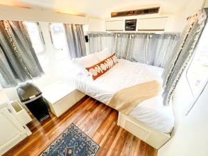 a bedroom with a bed in an rv at Riverside Airsteram Adventure in Colorado - Relaxation by the Water in Grand Junction in Grand Junction