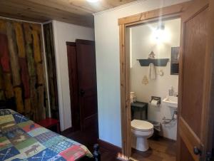a bathroom with a toilet and a sink at Enchanting Woodland Cabin Perfect for a Family Getaway on Moose Lake, Wisconsin in New Post +4 photos