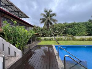 a swimming pool next to a house at Galle Beach Villa in Ratgama Hegoda