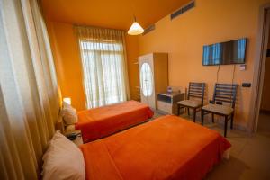A bed or beds in a room at Luani A Hotel
