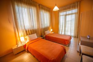 A bed or beds in a room at Luani A Hotel