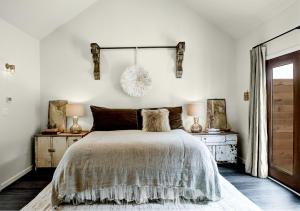 a bedroom with a large bed and two night stands at Modern Luxury Rental with Bohemian Decor near Antique Show in Round Top, Texas in Round Top