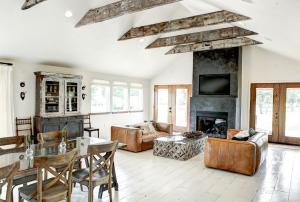 a living room filled with furniture and a fireplace at Modern Luxury Rental with Bohemian Decor near Antique Show in Round Top, Texas in Round Top