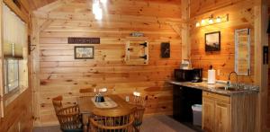 a log cabin kitchen with a wooden wall at Vacation Rental for Things to Do in Rocky Gap State Park in Flintstone