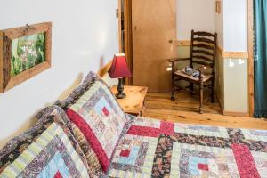 a room with a bed and a lamp and a chair at Private Cabin for Skiing Getaway with Deck in Steamboat Springs, Colorado in Columbine