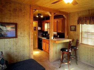 a kitchen with a counter and chairs in a cabin at Rustic Cabin Perfect for a Romantic Getaway in Inverness, Florida in Inverness