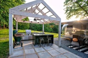 a pavilion with a grill and an rv parked at Unique Accommodation for a Glamping Getaway in Columbia, Pennsylvania in Columbia