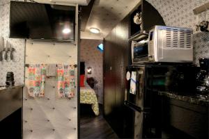 two pictures of a kitchen with a microwave at Unique Accommodation for a Glamping Getaway in Columbia, Pennsylvania in Columbia +4 photos