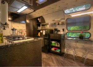 an rv kitchen with a counter and a stove at Unique Accommodation for a Glamping Getaway in Columbia, Pennsylvania in Columbia