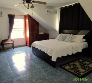 a bedroom with a large bed and a window at Villa Sunny Days in San Andrés +43 photos
