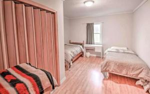 a bedroom with two beds and a window at Spacious Family Lake Vacation Rental near St David, Maine in Lavertue