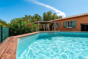 a swimming pool in front of a house at Villa in Méjannes-le-Clap