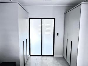 Un pasillo con una gran puerta de vidrio en un edificio. en The Blyde Inn, en Pretoria