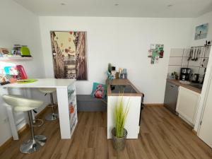 a small kitchen with a desk and a table at Fewo Happy Heede in Heede