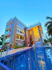 a large swimming pool in front of a building at Radiance Hotel in Trincomalee