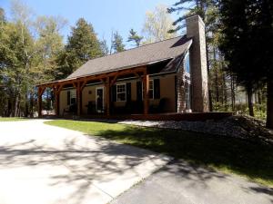 a small house in the middle of a road at Spacious Vacation Rental with a Stunning Stone Gas Fireplace in Fish Creek, Wisconsin in Fish Creek
