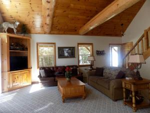 a living room with a couch and a table at Spacious Vacation Rental with a Stunning Stone Gas Fireplace in Fish Creek, Wisconsin in Fish Creek