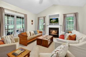 a living room with a fireplace and a couch at Resplendent Cabin Haven near Shenandoah River in Virginia in Bentonville