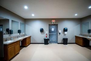 a bathroom with two sinks and a door in a room at Impressive Tented Cabin with Peaceful Vistas and Fire Pit in Logan, Ohio in Logan +26 photos