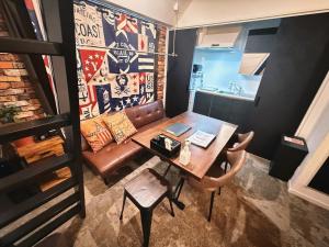 a living room with a table and a couch at Eternity APARTMENT HOTEL SHINAGAWA in Tokyo