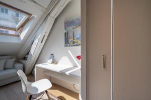 a room with a white desk and a chair at Studio sous les toits Annecy Centre-Ville in Annecy +25 photos