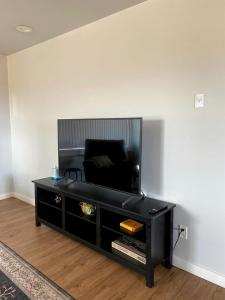 a living room with a black coffee table and a chair at Secluded Modern Vacation Home with Madison Range Views near Ennis Lake, McAllister Montana in Ennis