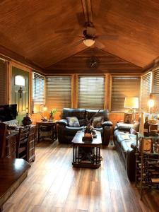 a living room with a couch and a table at Cozy Cabin for Glamping on a Texas Horse Ranch, Perfect for a Equine Escape in Kreutzberg