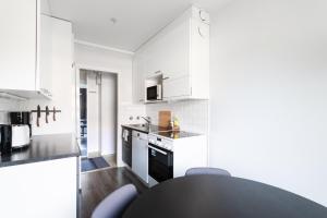 Kuchyň nebo kuchyňský kout v ubytování Cosy downtown apartment with balcony + 11 fotografií