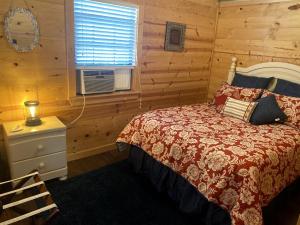a bedroom with a bed and a window at Rustic Dog-Friendly Cabin with Private Deck and Hot-Tub in Texas in Wimberley