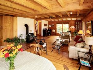 a living room with a table and a fireplace at Luxury Log Cabin with 18 Acres of Countryside and Swimming Pond near Athens, Ohio in Athens